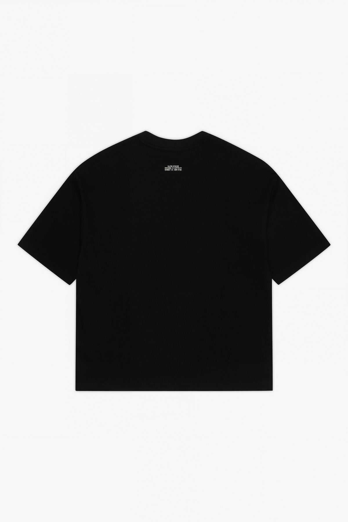 Black Stamp Tee, back view, with a white garment ID print below the neckline.