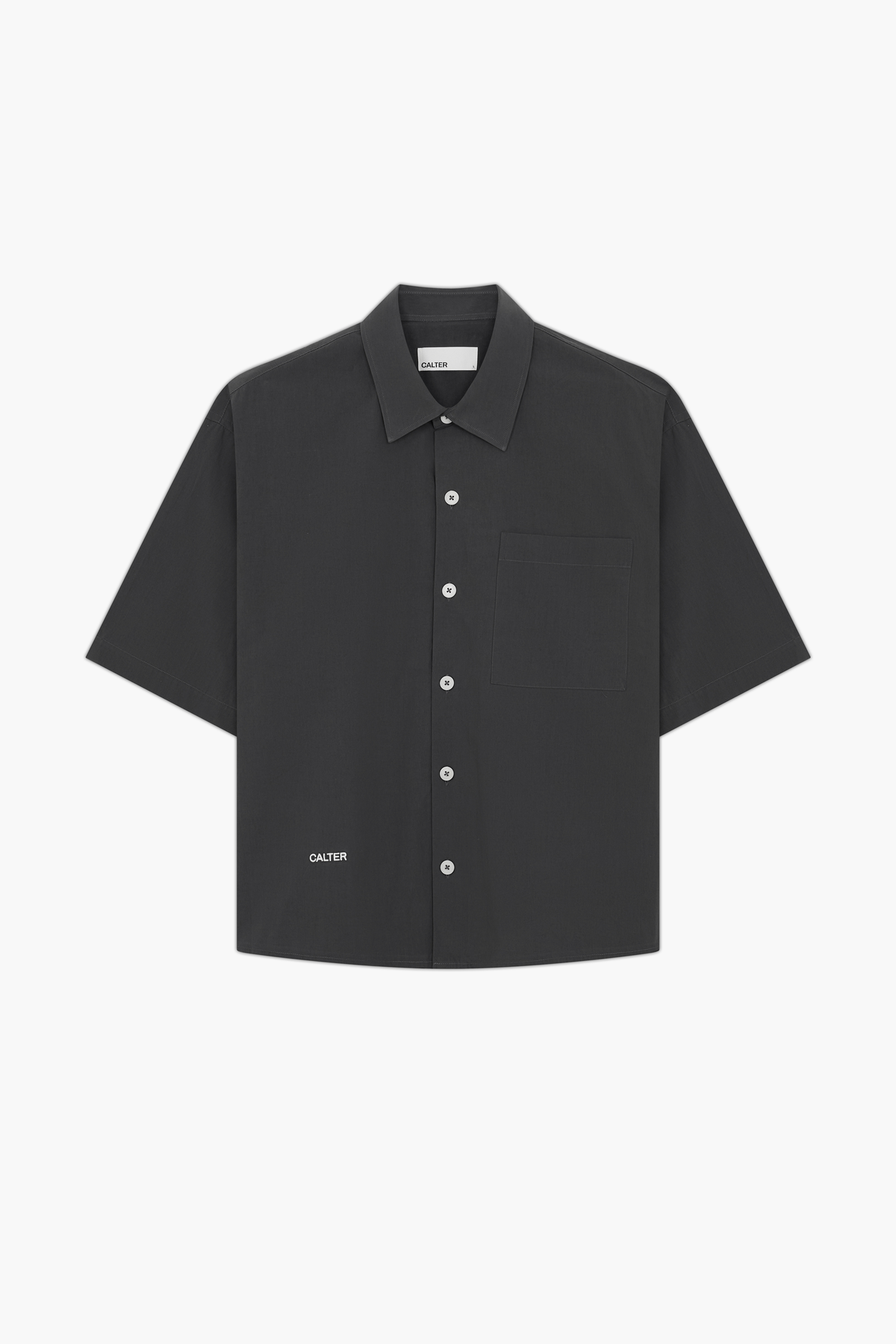 Charcoal Volume Shirt, front view, showing the short sleeves, chest patch pocket and contrast front-hem embroidery.
