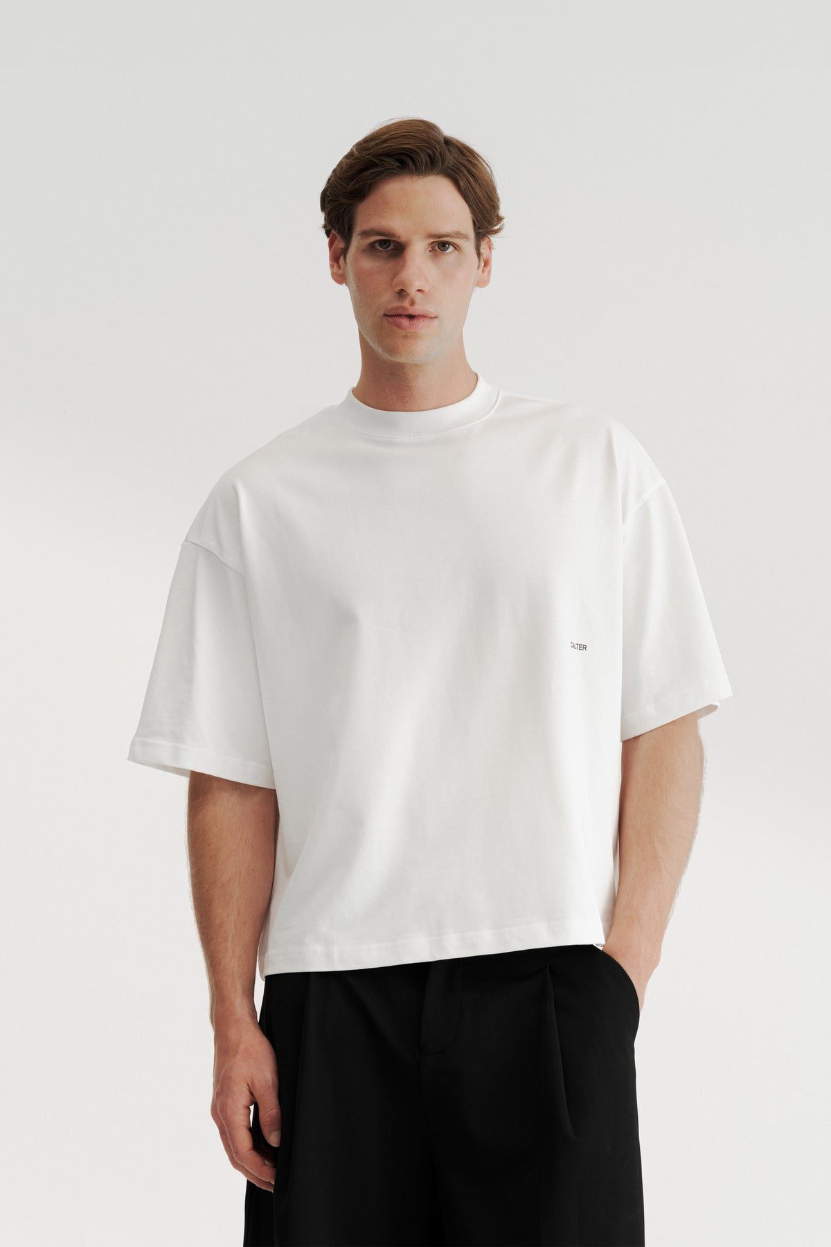 Model wearing the Off-White Stamp Tee, showing its wide body, dropped shoulders and shortened length.