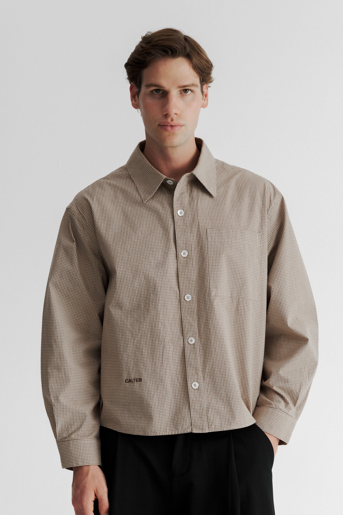 Model wearing the Sand Microcheck Studio Shirt, showing the wide proportions and shortened body length.