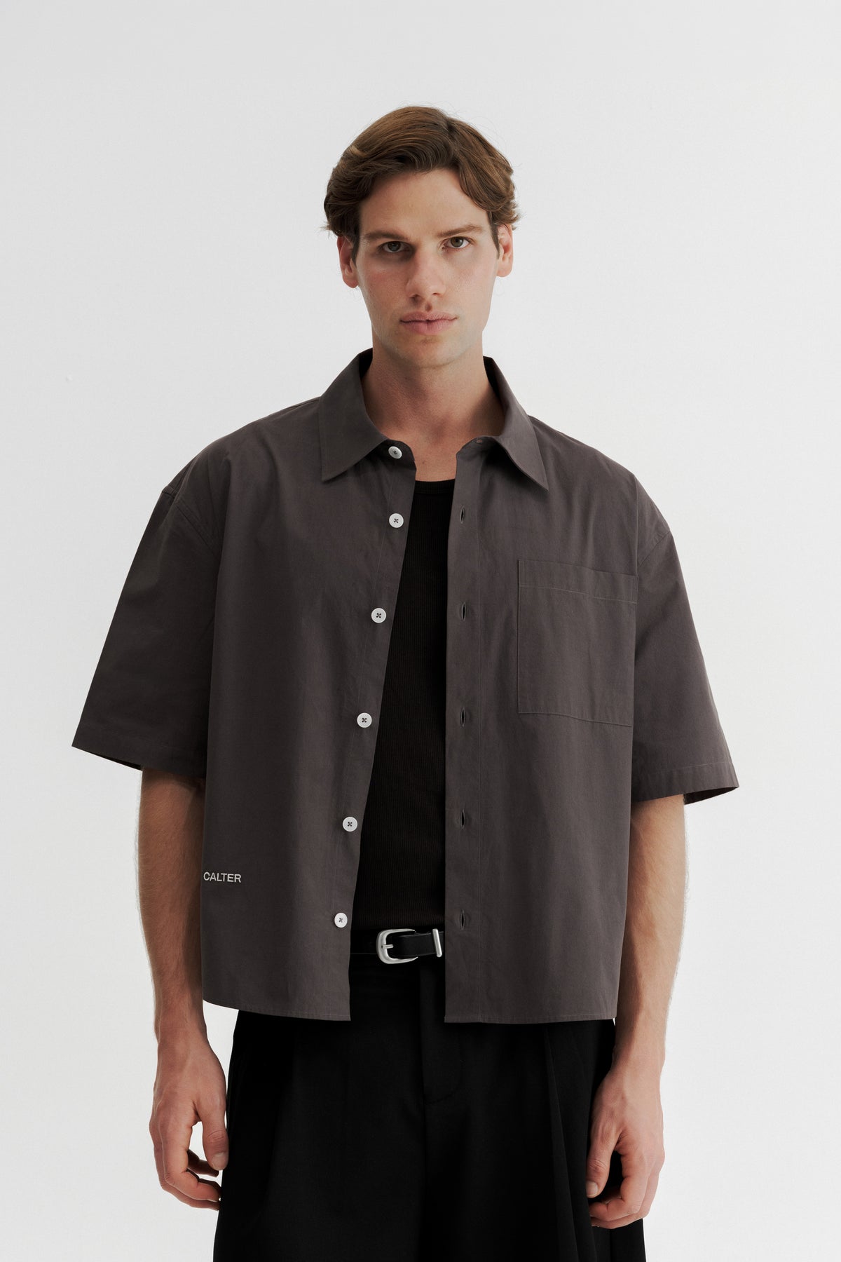 Model wearing the Charcoal Volume Shirt open over a black tank top, showing the wide chest and sleeves.